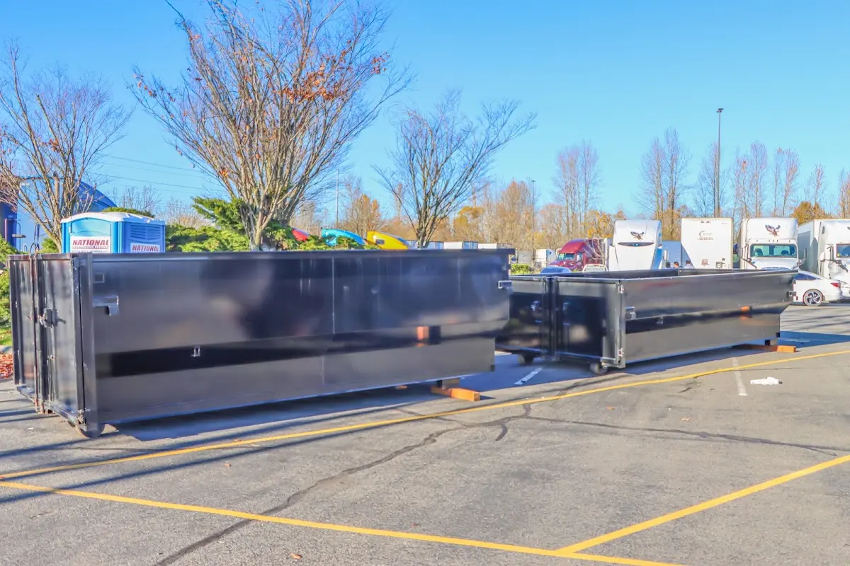 Professional dumpster rental service with roll-off container on residential driveway in Lemont